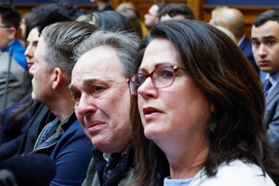 Dean and Michelle Nasca, whose son Chase allegedly committed suicide after receiving unsolicited suicidal videos in TikTok, react as TikTok Chief Executive Shou Zi Chew testifies before a House Energy and Commerce Committee hearing on Capitol Hill in Washington, US, 23 March 2023. (Evelyn Hockstein/Reuters)