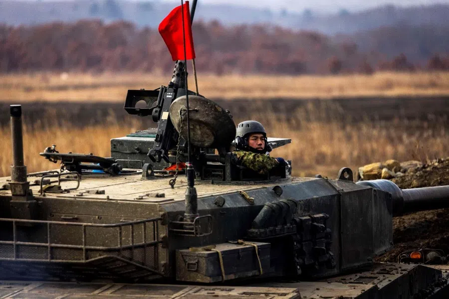 A Japan Ground Self-Defense Force Northern Army Type-90 tank participates in a live tank firing competition at the Hokkaido Great Maneuvering Ground in Eniwa, Hokkaido prefecture on 7 December 2021. (Behrouz Mehri/AFP)