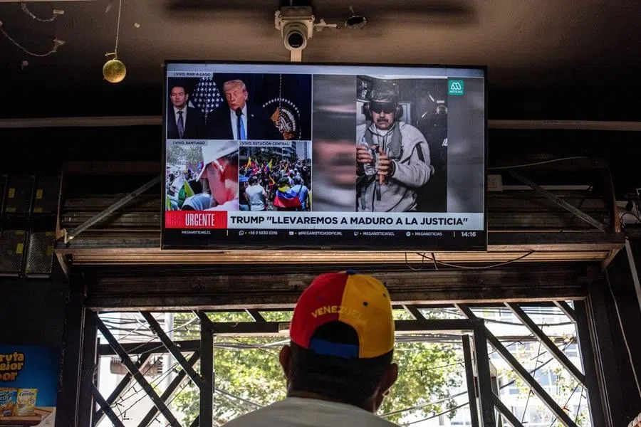 A resident watches a news broadcast about ousted Venezuelan President Nicolas Maduro, at a store in Santiago, Chile, on 3 January 2026. (Cristobal Olivares/Bloomberg)