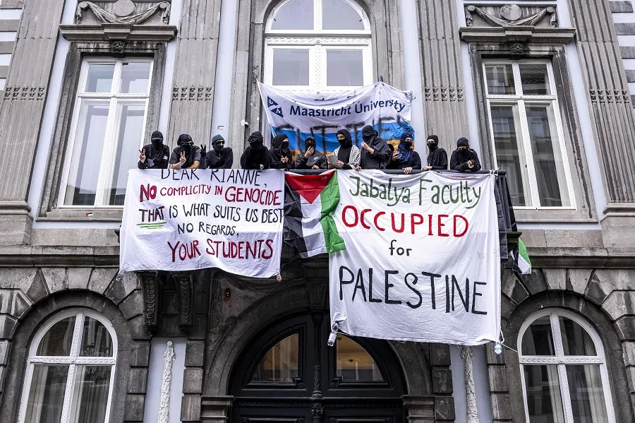 Students display banners as they occupy the socio-cultural sciences faculty building of Maastricht University (UM) in support of Palestinian people, in Maastricht, the Netherlands on 22 May 2024. (Marcel van Hoorn/ANP/AFP)