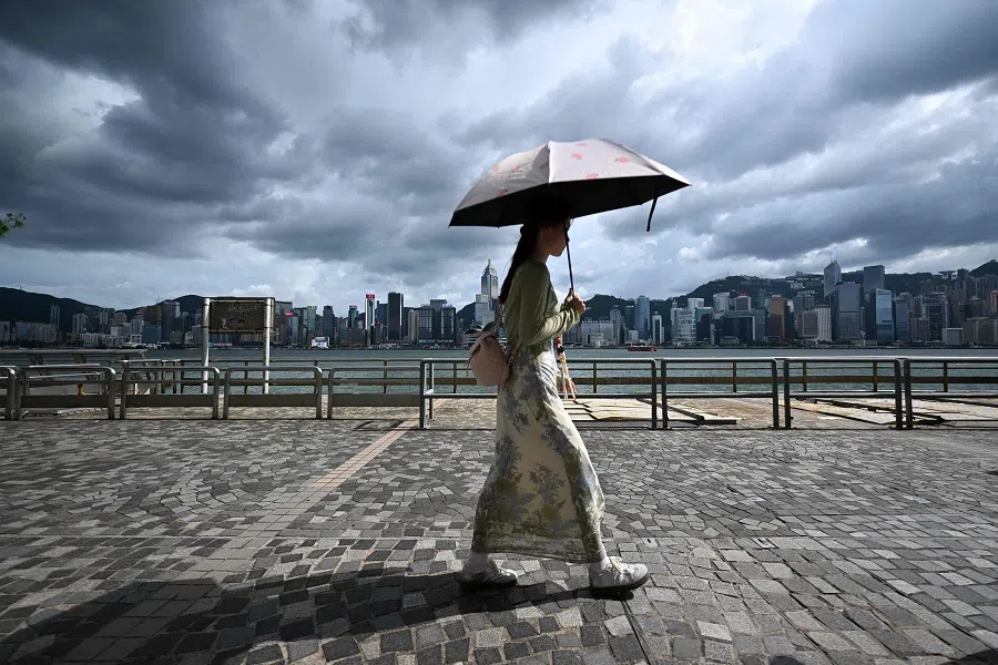 Tourists walk on the promenade at Victoria harbour in Hong Kong on 5 September 2024, as super typhoon Yagi tracked across the South China Sea towards the southern China coast.