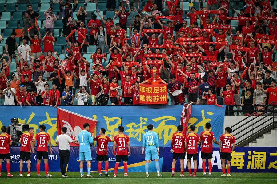 The Suzhou amateur football team thank their fans at the Kunshan Olympic Sport Center in Kunshan, in eastern China’s Jiangsu province on 29 June 2025. (Hector Retamal/AFP)
