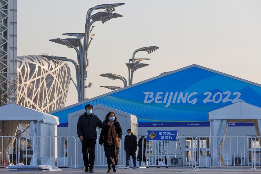 People walk outside a "closed loop" area designed to prevent the spread of the coronavirus disease (Covid-19) near the National Stadium, a venue of the Beijing 2022 Winter Olympics in Beijing, China, 6 January 2022. (Thomas Peter/Reuters)
