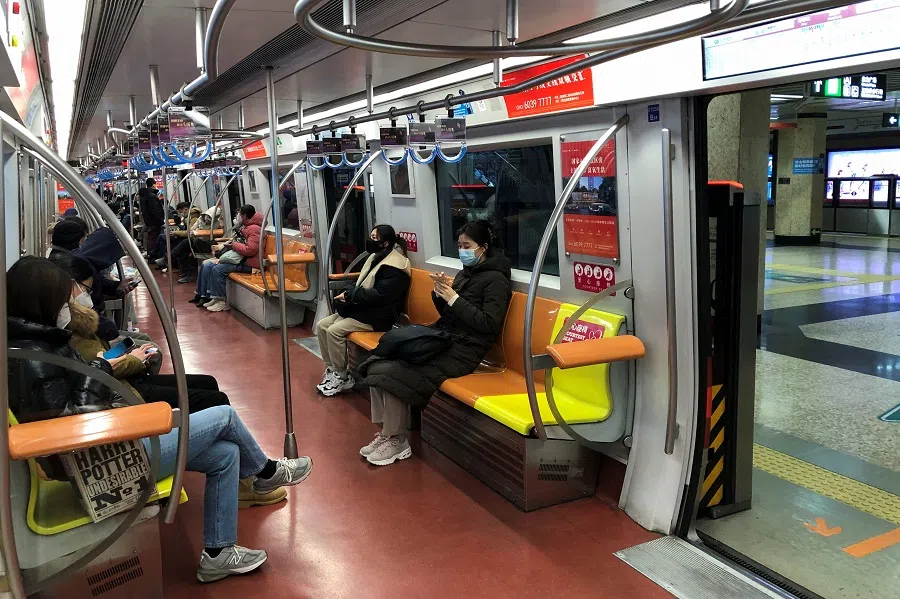 People ride on a subway during evening rush hour in Beijing, China, 9 December 2022. (Ryan Woo/Reuters)