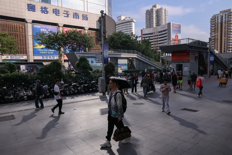 People walk past Huaqiangbei electronics market in Shenzhen, Guangdong province, China, 30 October 2025. (Tingshu Wang/Reuters)