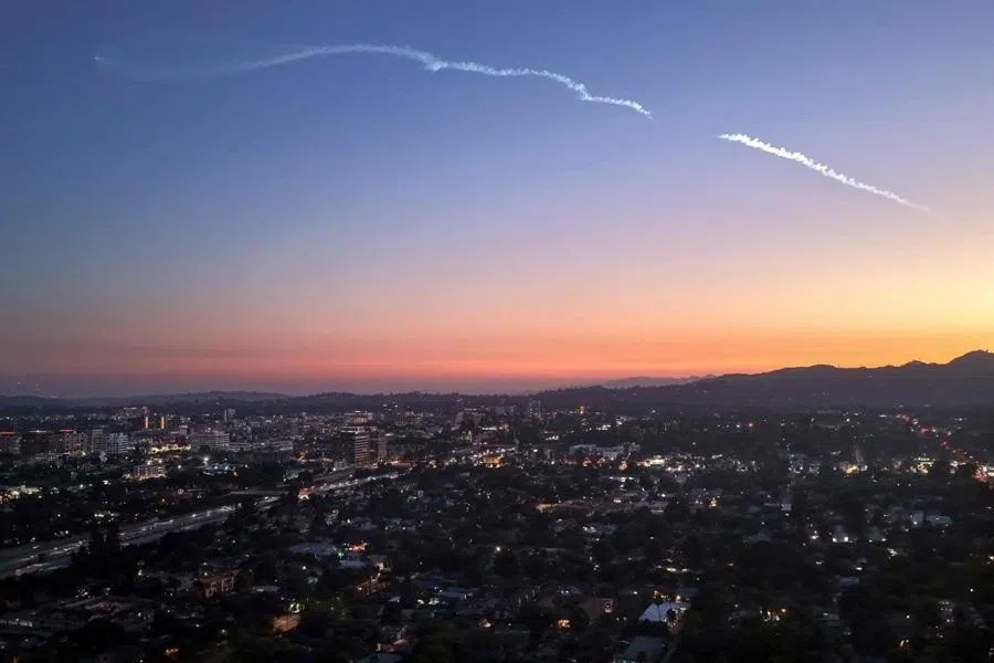 In an aerial view, a SpaceX Falcon 9 rocket rises after launching from Vandenberg Space Force Base carrying 24 Starlink internet satellites on 24 June 2026 in Pasadena, California.