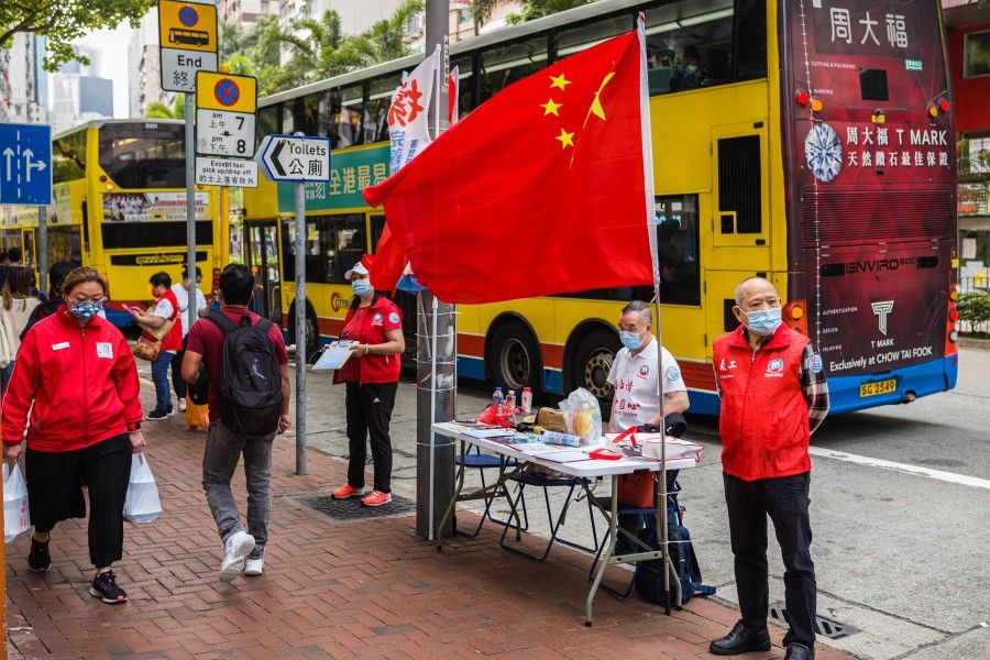 China's national flag is displayed at a stall where residents can sign in favour of changes to the local electoral system in Hong Kong on 11 March 2021, after China's parliament voted overwhelmingly for changes to Hong Kong's electoral system including plans to grant Beijing veto powers over candidates, as leaders move towards a "patriotic" government after huge democracy rallies in the city. (Anthony Wallace/AFP)