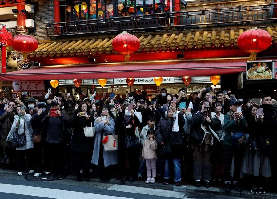 Onlookers watch a lion dance performance as part of Chinese Lunar New Year celebrations in Chinatown in Yokohama, south of Tokyo, Japan, on 17 February 2026.