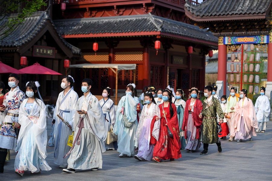People dressed in Hanfu, or Han clothing, walk at a theme park on Chinese National Costume Day in Changsha, Hunan province, China, 26 March 2020. (CNS photo via Reuters)