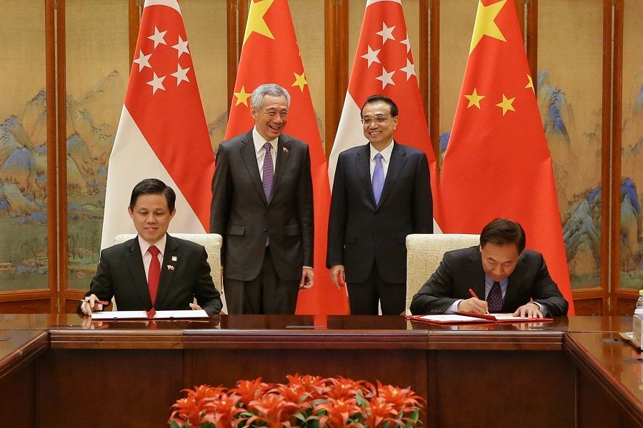 Singapore Prime Minister Lee Hsien Loong (standing, left) and Chinese Premier Li Keqiang (standing, right) witnessing the MOU-signing at the Diaoyutai State Guesthouse in Beijing on 29 April 2019. Representing Singapore is Minister of Trade and Industry Mr Chan Chun Sing (sitting, left) and China's National Development and Reform Commission Vice-Chair Zhang Yong. (SPH)