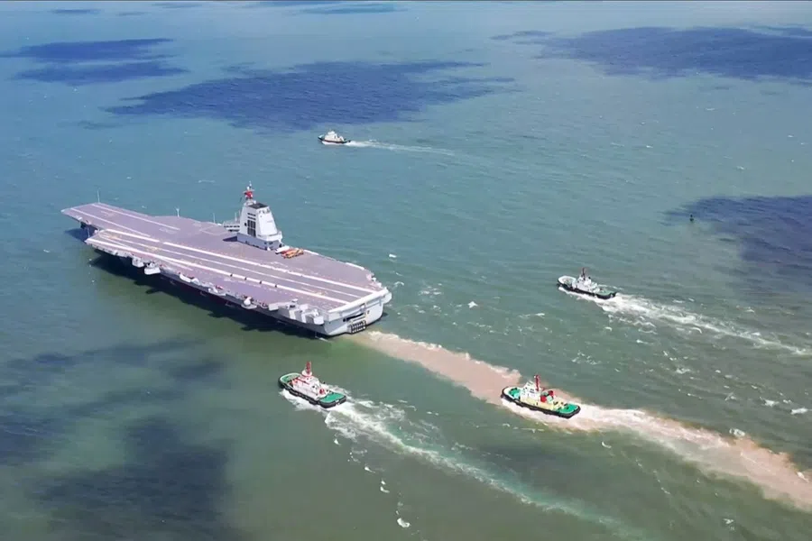 This screen grab from video footage from China's Ministry of Defence taken in May 2024 and released via AFPTV on 11 May 2024 shows China's third aircraft carrier Fujian carrying out sea trials at sea in an unknown location. (China’s Ministry of Defence/Handout via AFP)