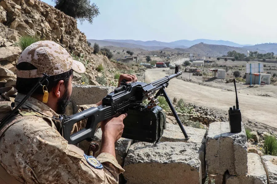 A Taliban security personnel stands guard along a road near the Ghulam Khan zero-point border crossing between Afghanistan and Pakistan in Gurbuz district in the southeast of Khost province on 20 October 2025. (AFP)