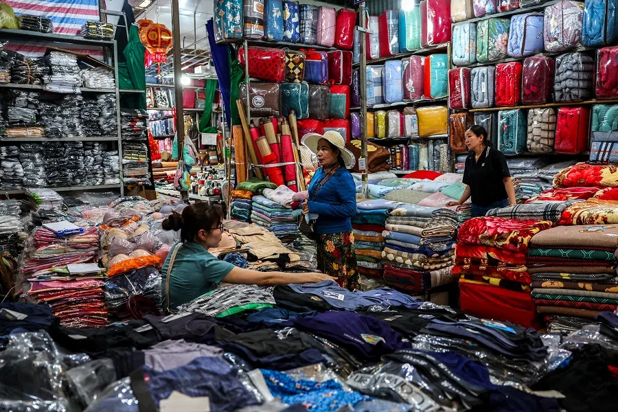 People shop inside a market in Dong Dang township, Lang Son province, Vietnam, on 17 April 2025. (Athit Perawongmetha/Reuters)