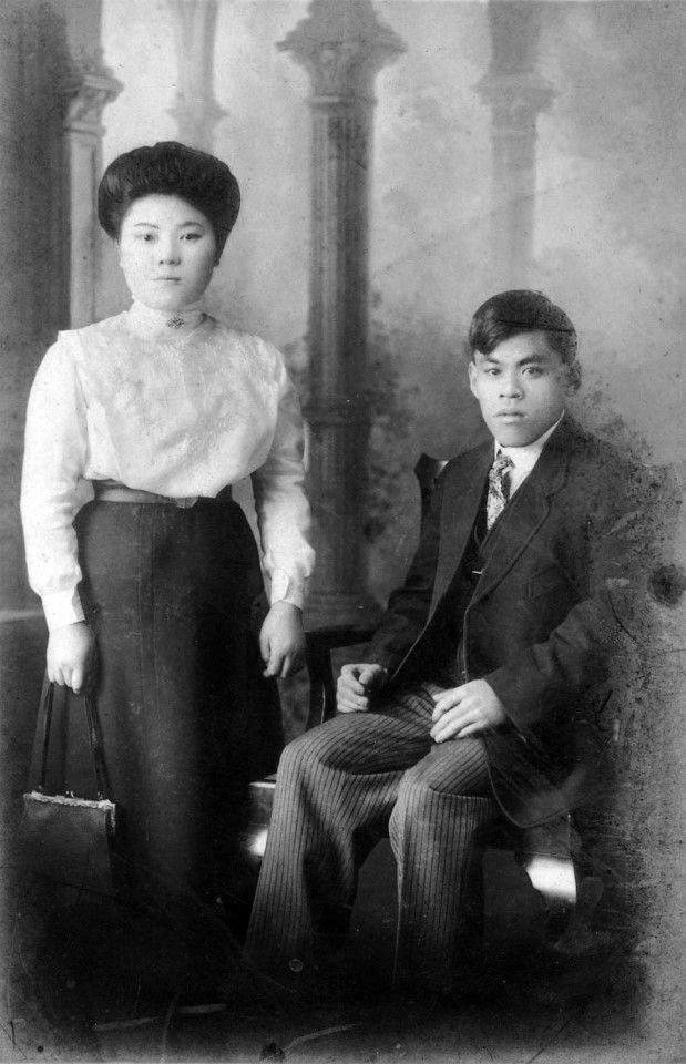 A portrait photograph of a Chinese couple in the US, 1900s, a rosy representation of the Chinese seeking a new life in the US.