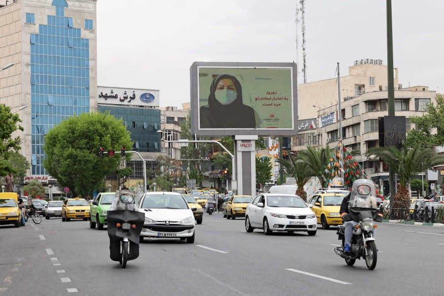 Iranians drive down a street in the capital Tehran, on 11 April 2021. (Atta Kenare/AFP)