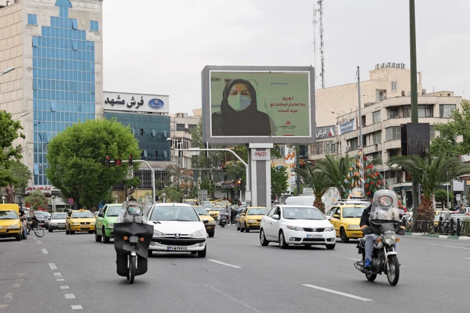 Iranians drive down a street in the capital Tehran, on 11 April 2021. (Atta Kenare/AFP)