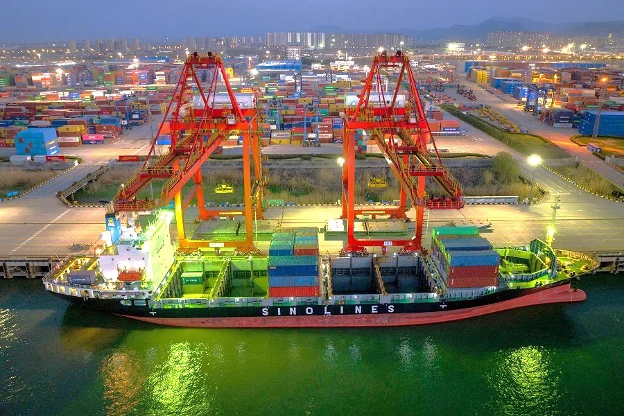 Ships and containers are seen at the container port in Nanjing, Jiangsu province, China, on 19 March 2024. (AFP)