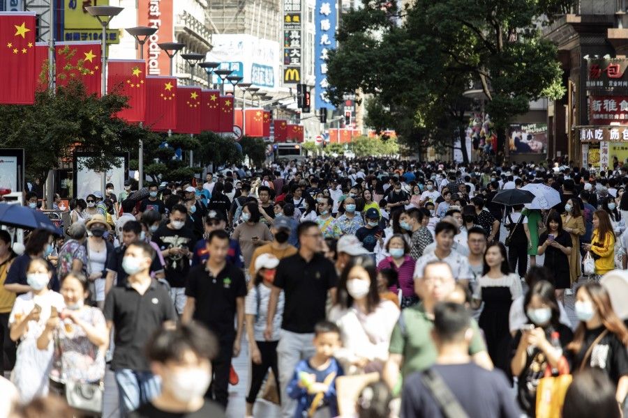 Shoppers and visitors walk along Nanjing Road East in Shanghai, China, on 3 October 2021. (Qilai Shen/Bloomberg)