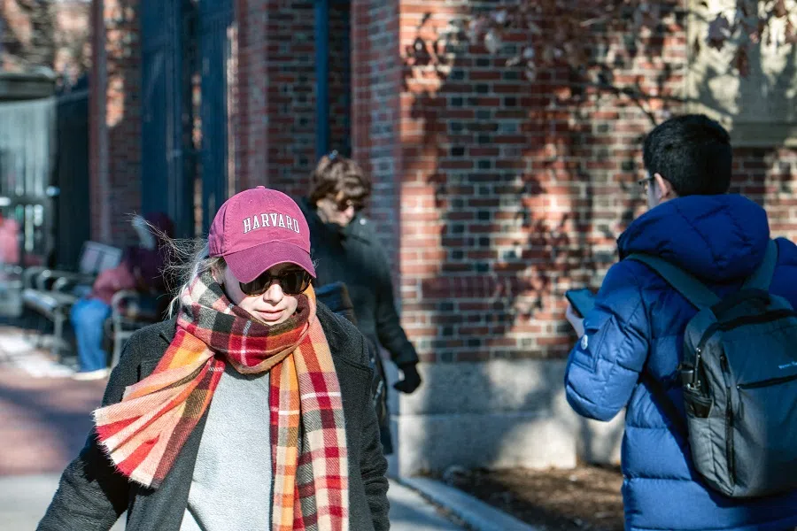 People walk by Harvard Yard in Harvard University in Cambridge, Massachusetts on 12 December 2023. (Joseph Prezioso/AFP)