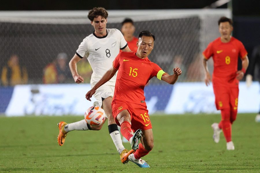 China's Wu Xi controls the ball during the football match between New Zealand and China at Mt Smart Stadium in Auckland, New Zealand, on 23 March 2023. (Michael Bradley/AFP)