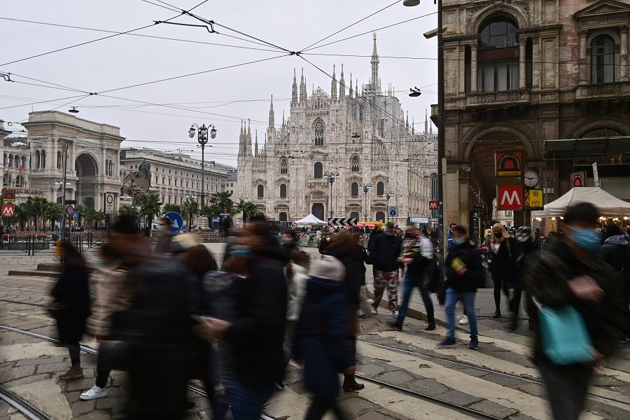 People walk by Duomo square in downtown Milan, Italy, on 6 February 2021. (Miguel Medina/AFP)