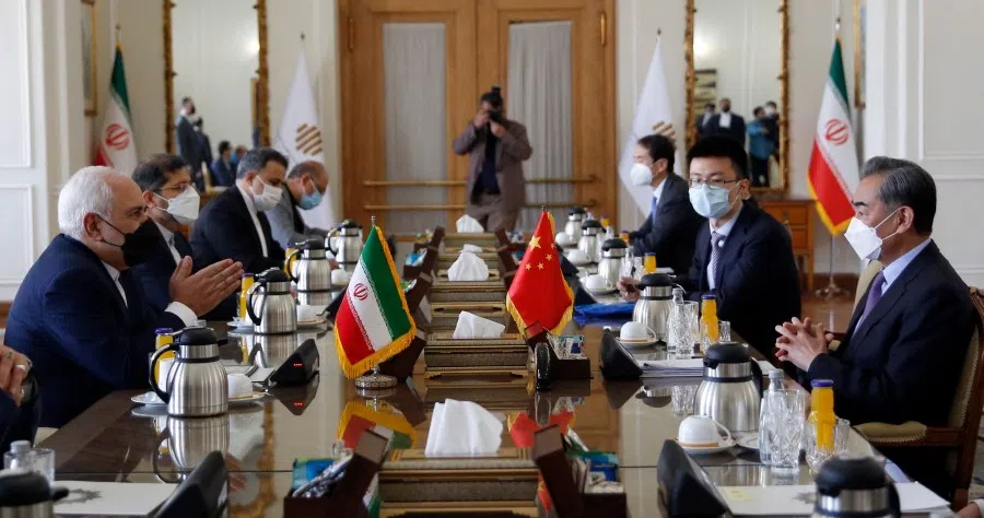 Iranian Foreign Minister Mohammad Javad Zarif (left) meets with his Chinese counterpart Wang Yi (right), in the capital Tehran, on 27 March 2021. (AFP)