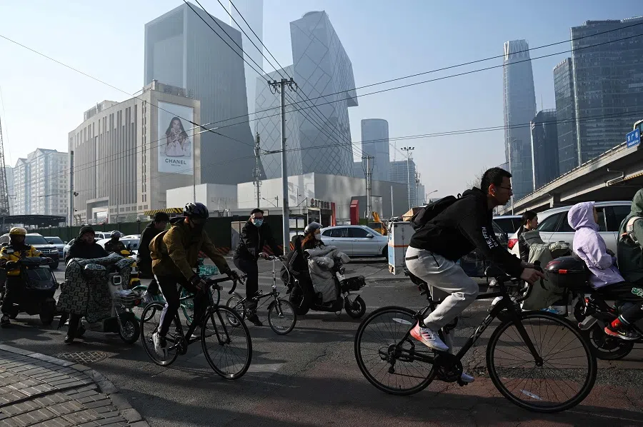 People on their way to work in Beijing’s central business district on 10 April 2025. (Greg Baker/AFP)