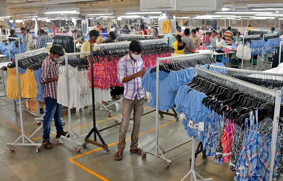 Workers inspect brand tags on apparel ready for packaging at a textile factory of Texport Industries in Hindupur town in the southern state of Andhra Pradesh, India, on 9 February 2022. (Samuel Rajkumar/Reuters)