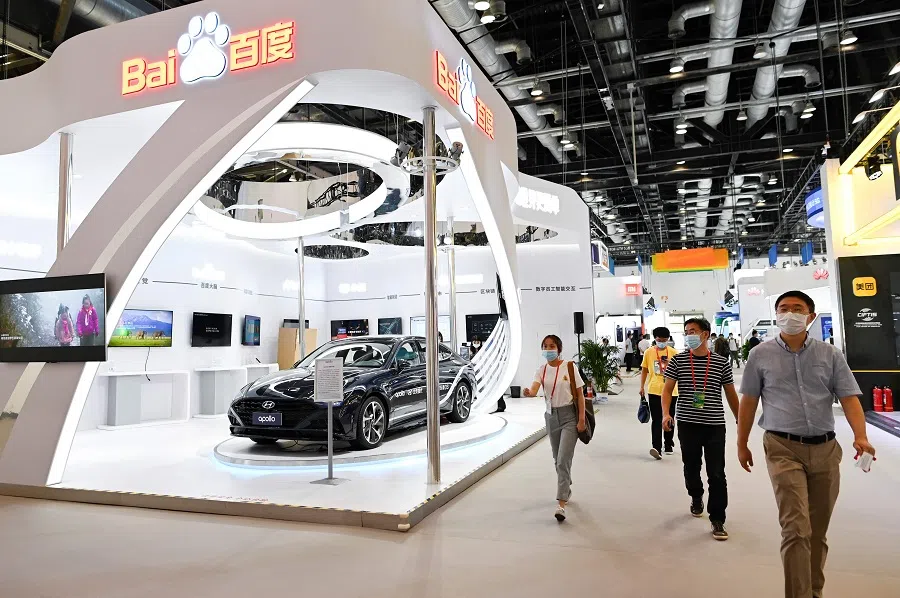 A group of people walk past the Baidu booth at the China National Convention Centre, the venue for the China International Fair for Trade in Services (CIFTIS) in Beijing on 3 September 2020. (Wang Zhao/AFP)