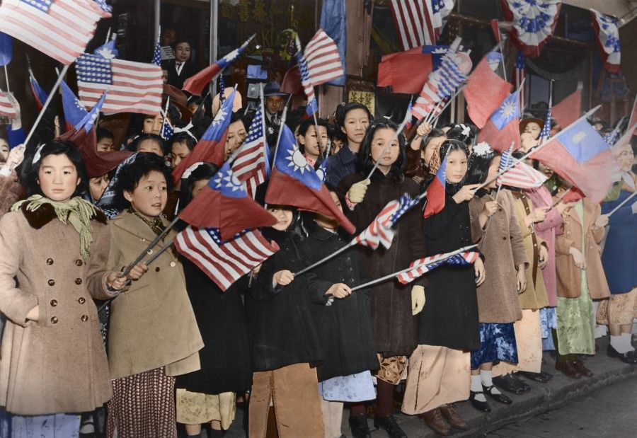 March 1943, New York - Chinese-American children standing along the streets in Chinatown, waving ROC and American flags to welcome Madame Chiang.