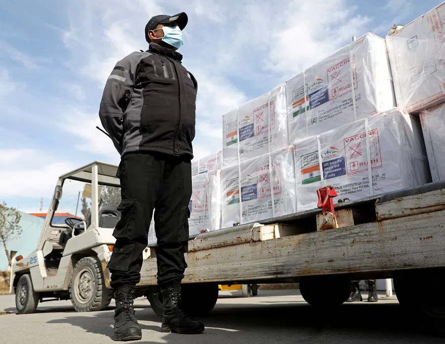 An Indian security personnel stands guard next to the boxes containing vials of Covishield, a Covid-19 vaccine donated by Indian government in Kabul, Afghanistan, 7 February 2021. (Omar Sobhani/File Photo/Reuters)