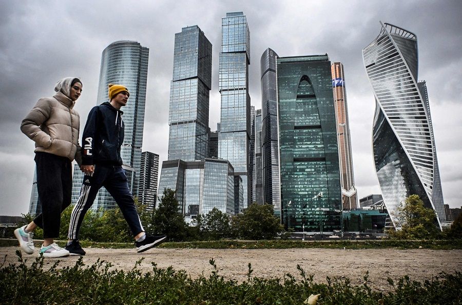 People walk past the buildings of Moscow's International Business Centre (Moscow-City) in Moscow, Russia, on 8 September 2022. (Alexander Nemenov/AFP)
