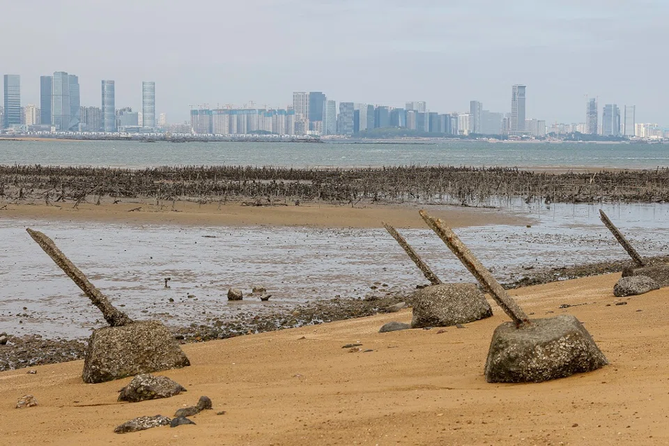 Anti-landing barricades are seen on the beach with China's Xiamen in the background in Kinmen, Taiwan, on 18 December 2023. (Ann Wang/Reuters)