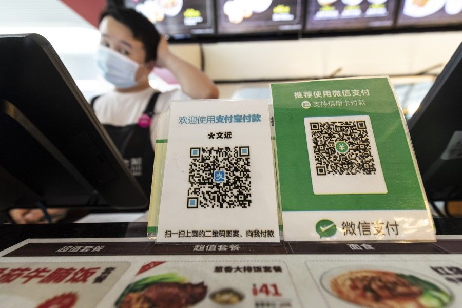 QR codes for Ant Group Co.'s Alipay digital payment service and Tencent Holdings Ltd.'s WeChat Pay at a restaurant in Hangzhou, China, on 2 November 2020. (Qilai Shen/Bloomberg)