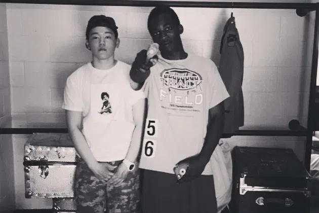 A photo of the author in high school posing with a friend, wearing a Supreme shirt and Bape shorts. (Lu Lingming)
