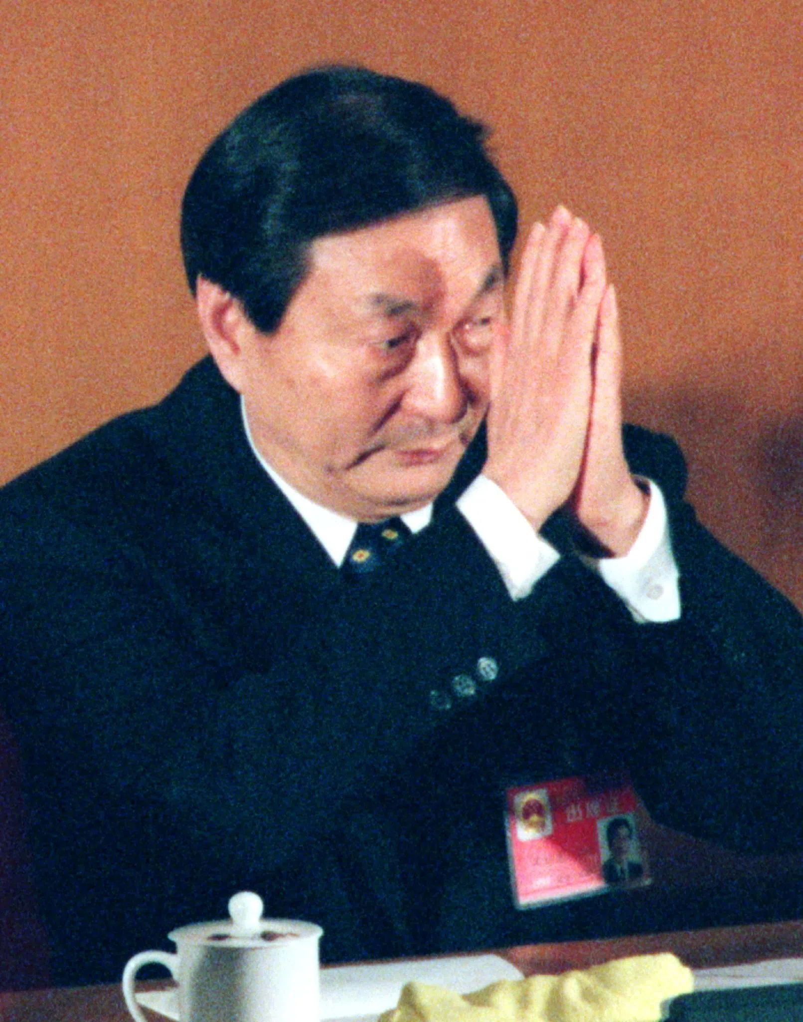 China's reformist economic tsar Zhu Rongji clasps his hands to acknowledge applause after a National People's Congress official announced that he was elected as premier.