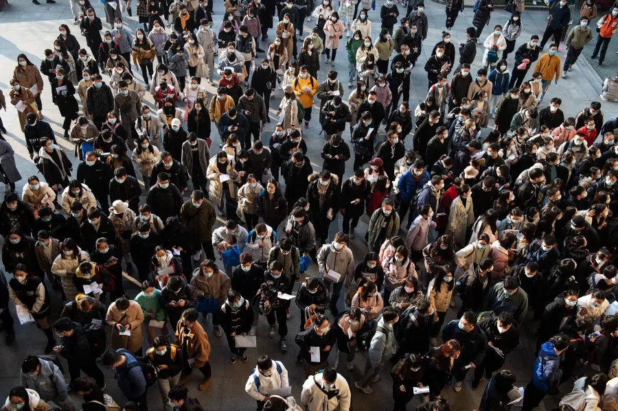 This aerial photo taken on 28 November 2021 shows candidates preparing to take the national examination for admissions to the civil service in Wuhan in China's central Hubei province. (AFP)