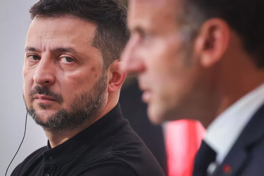 Ukraine's President Volodymyr Zelensky (left) looks at France's President Emmanuel Macron as he speaks during a press conference at the Elysee Presidential Palace, in Paris, on 4 September 2025.