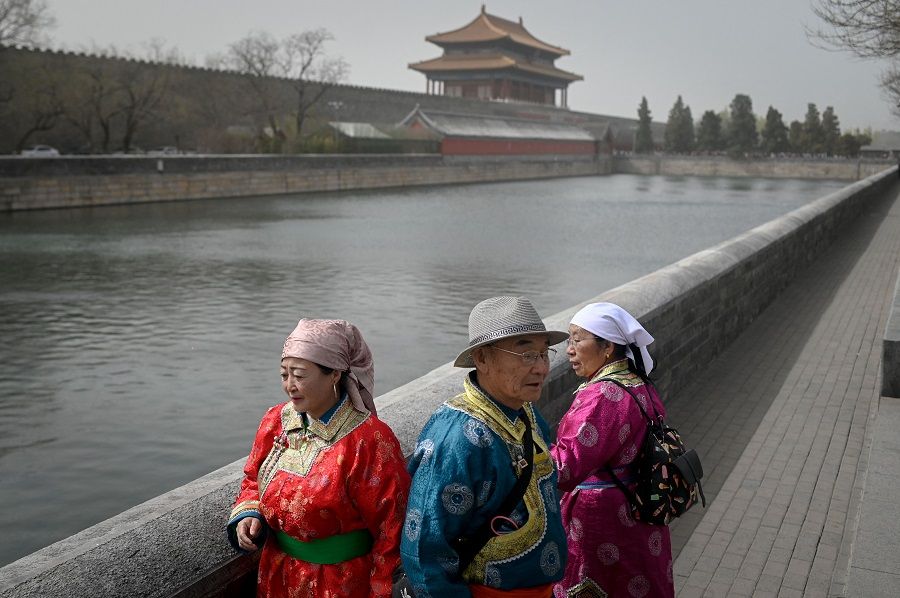 Tourists walk outside the Forbidden City in Beijing, China, on 22 March 2023. (Wang Zhao/AFP)