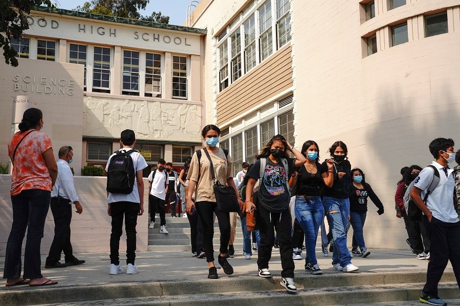 Students exit Hollywood High School after the first day of school in Los Angeles, California, US on 16 August 2021. (Bing Guan/Bloomberg)