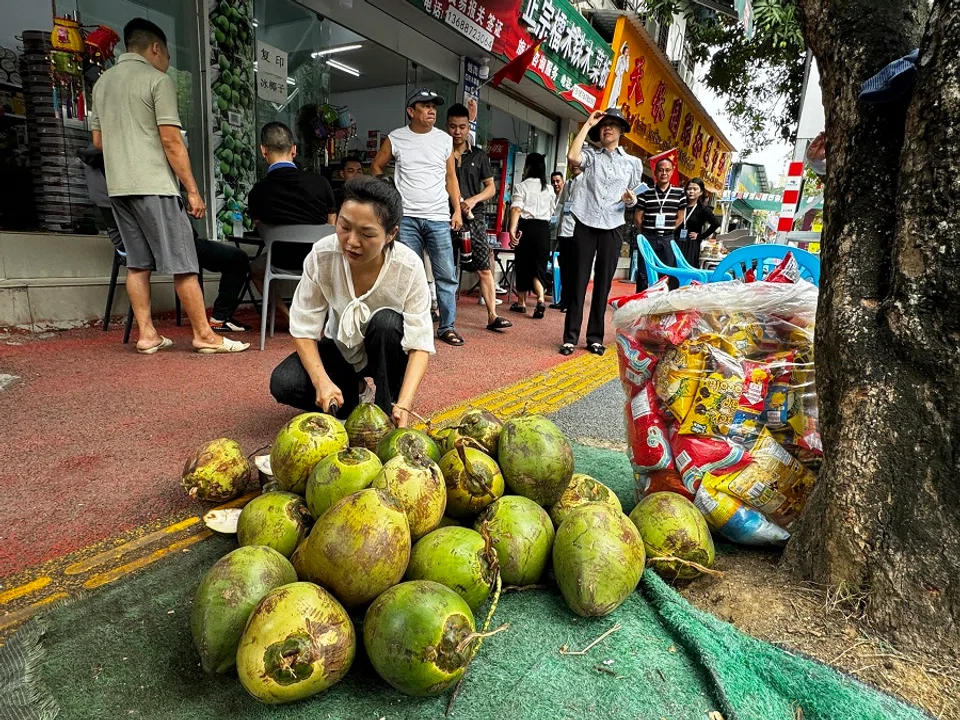 Border residents selling coconuts. (Sim Tze Wei/SPH Media)