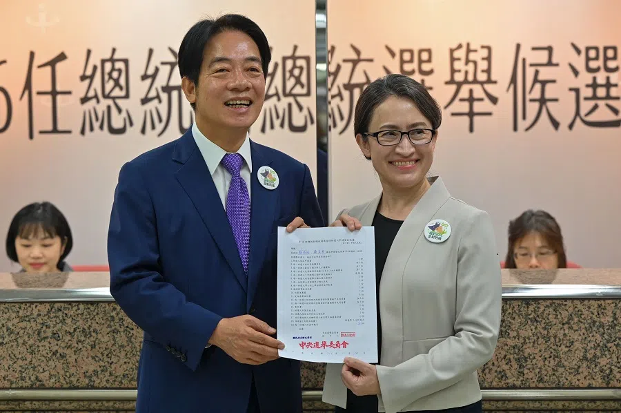 Taiwan presidential candidate Lai Ching-te (left) and his running mate Hsiao Bi-khim (right), from the ruling Democratic Progressive Party (DPP), display a document at the Central Elections Committee after they registered running for the 2024 presidential elections in Taipei on 21 November 2023. (Sam Yeh/AFP)