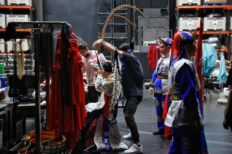 The production crew helping Li Jia-de with his headpiece before the rehearsal at the Esplanade Theatre, 20 July 2023. “A Show Of Prowess” by Taiwanese troupe GuoGuang Opera Company highlights feats of martial arts and complex footwork. (SPH Media)