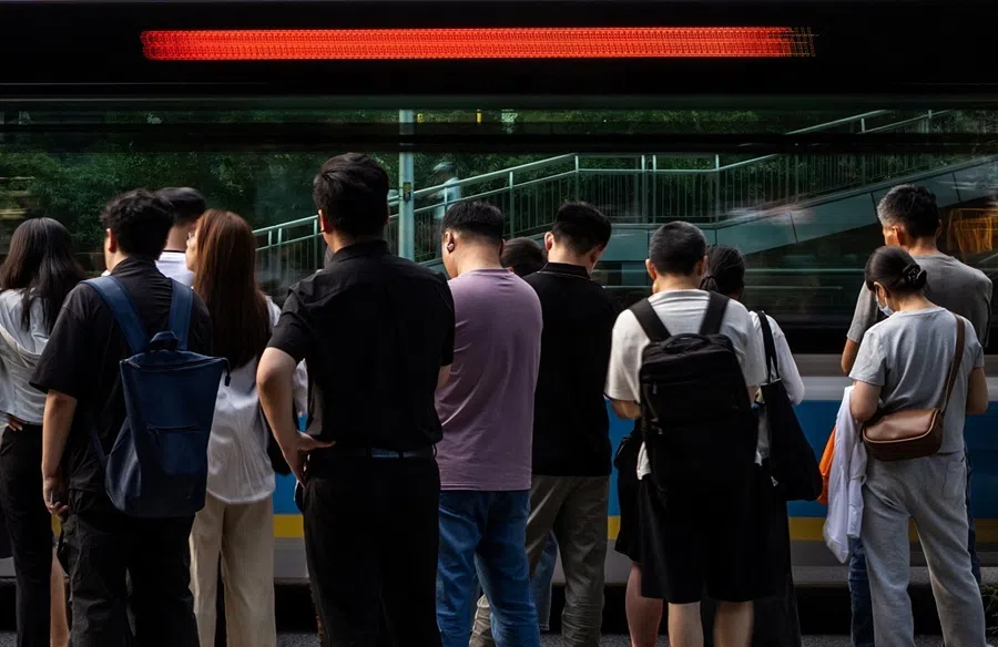 People queue to board a commuter bus after work in Beijing's Central Business District (CBD), China, 6 July 2026.