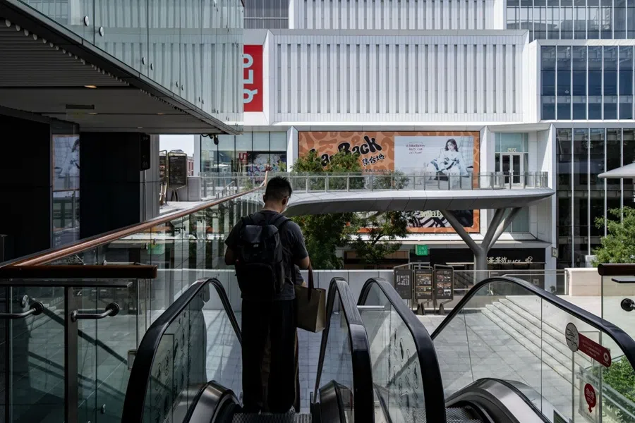 Shoppers on an escalator at a shopping mall in Beijing, China, on 26 August 2025. (Qilai Shen/Bloomberg)