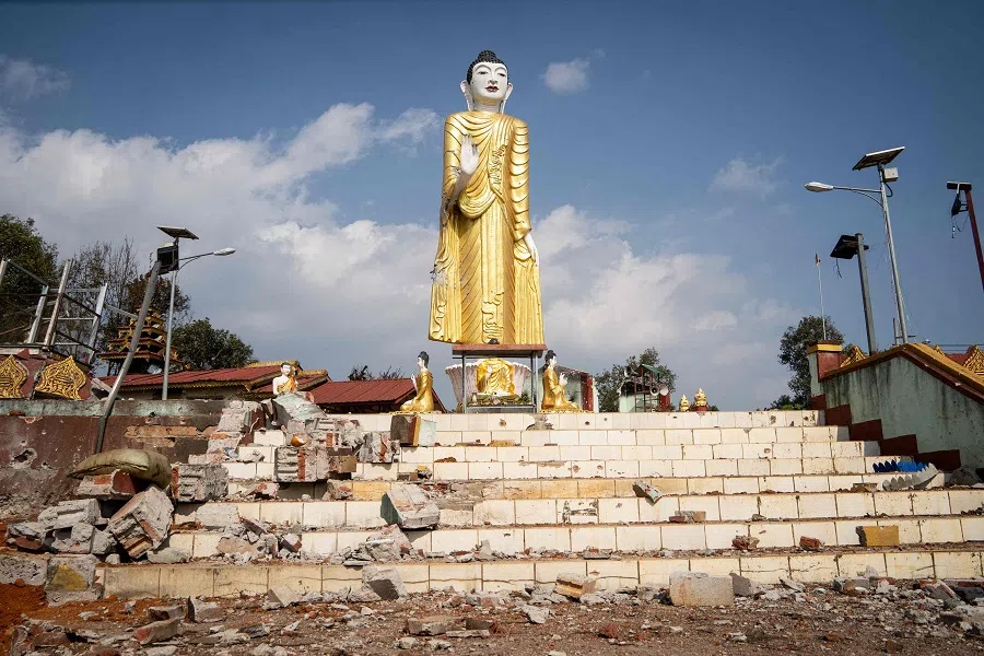 Debris is pictured next to a damaged Buddha statue following fighting between Myanmar's military and the Kachin Independence Army in Nam Hpat Kar, Kutkai township, in Myanmar's northern Shan State on 4 February 2024. (AFP)