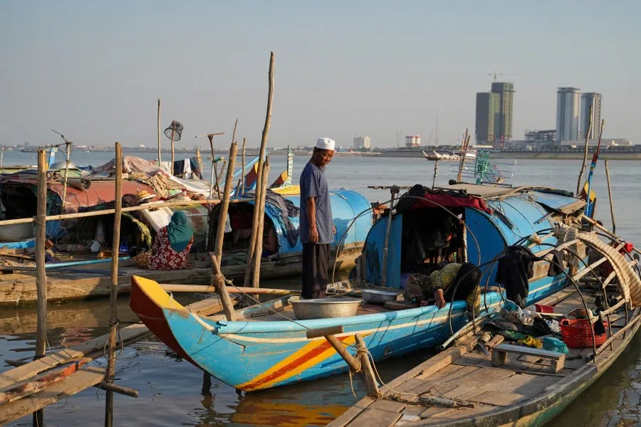 A Cambodian fisherman stands on his boat on the Mekong river in Phnom Penh, Cambodia, 19 February 2021. (Cindy Liu/Reuters)