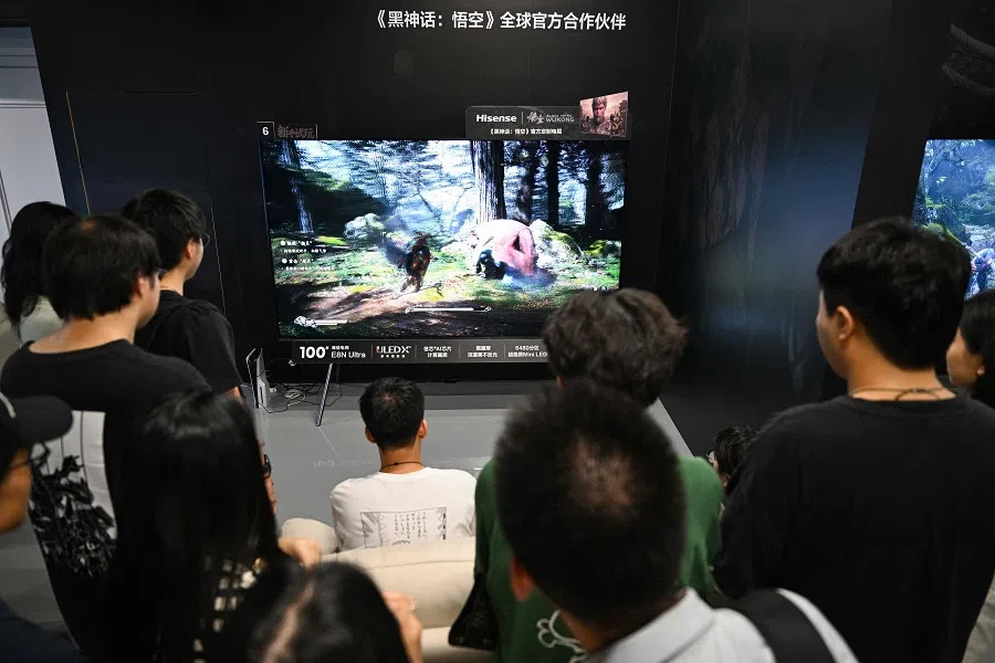 A young man plays Chinese action role-playing game Black Myth: Wukong, developed by Chinese video game company Game Science, during its launch day in Shanghai on 20 August 2024. (Hector Retamal/AFP)