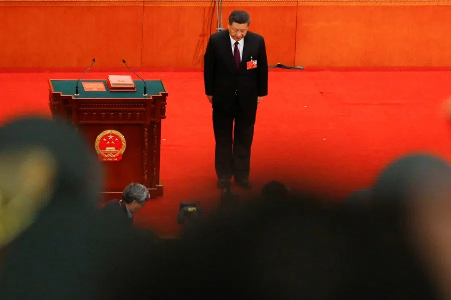 Chinese President Xi Jinping bows to the delegates after being confirmed president for another term during the fifth plenary session of the National People's Congress (NPC) at the Great Hall of the People in Beijing, China, 17 March 2018. (Thomas Peter/Reuters)