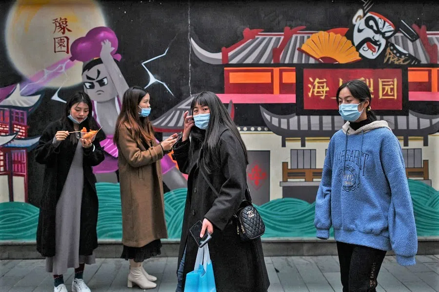Women visit a tourist area in Shanghai on 8 March 2021. (Hector Retamal/AFP)